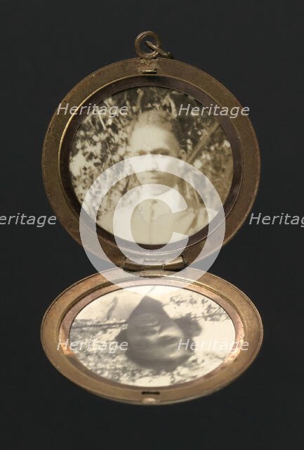 Locket with photographs of Harriette and Harry T. Moore, early to mid 20th century. Creator: Unknown.