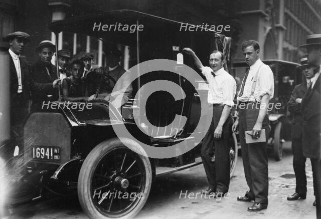 Inspector Walsh condemning taxicab, 1913. Creator: Bain News Service.