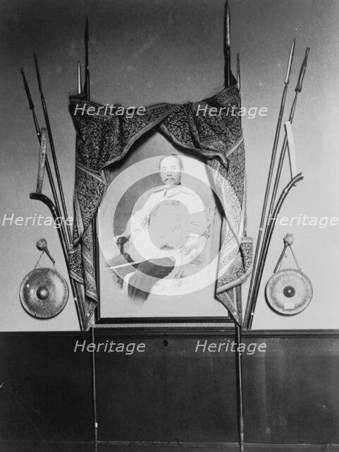 Display with portrait of a man, possibly Chulalongkorn, King of Siam, in Siam exhibit..., 1904. Creator: Frances Benjamin Johnston.