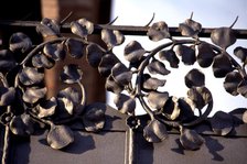 Detail of wrought iron with floral motifs of the old Modernist textile factory Casaramona's gate,…
