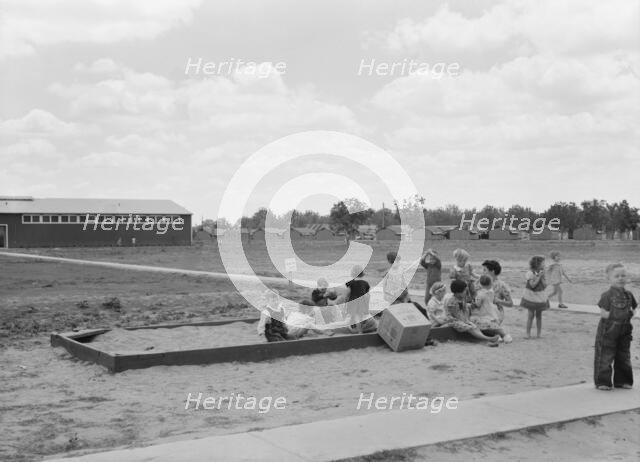 Nursery school children with their teacher, FSA camp, Tulare County, California, 1939. Creator: Dorothea Lange.