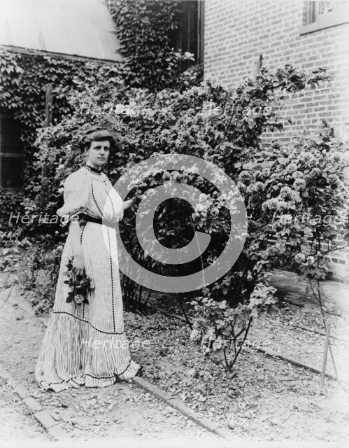 Frances Benjamin Johnston, full-length portrait, standing in her garden..., c1890 - 1910. Creator: Unknown.