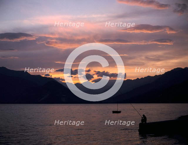 Fisherman at sunset, Lake Maggiore, Italy.