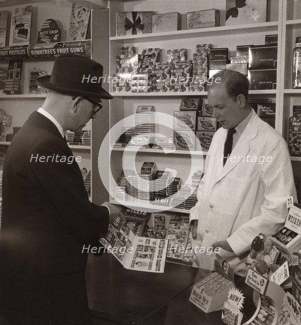 A salesman demonstrating his goods, 1956. Artist: Unknown