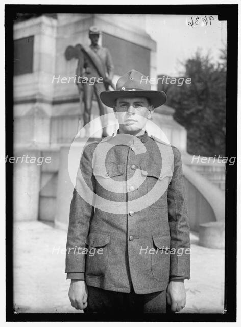 Young man in uniform standing in front of Sherman Monument, Washington, D.C., between 1916 and 1918. Creator: Harris & Ewing.