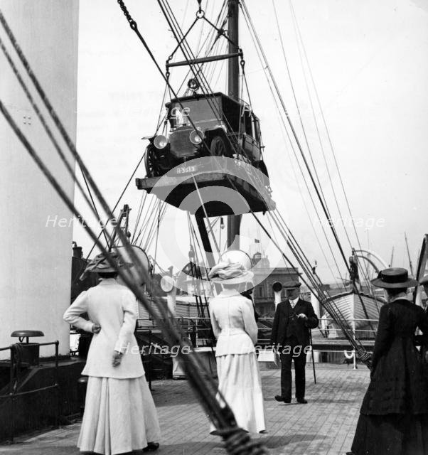 1910 Mercedes being craned onboard ship. Creator: Unknown.