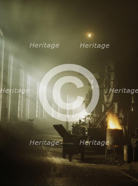 In the roundhouse at a Chicago and North Western Railroad yard, Chicago, Ill., 1942. Creator: Jack Delano.
