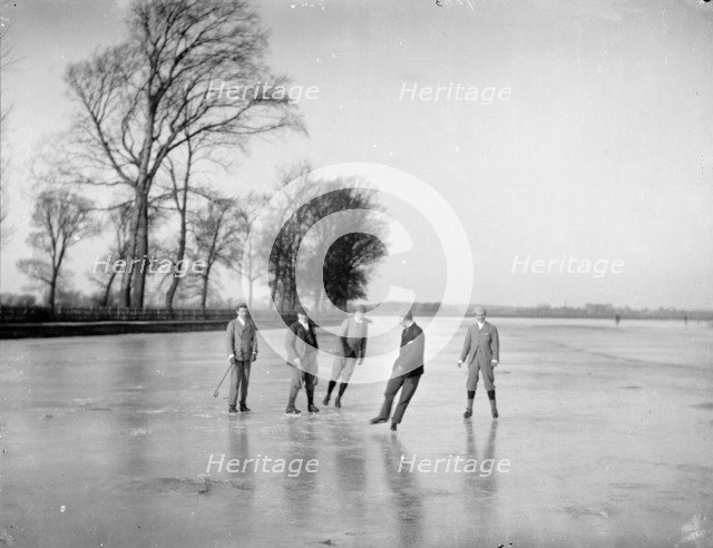 Men playing ice hockey on the frozen Medley Port Meadow, Oxford, Oxfordshire, c1860-c1922. Artist: Henry Taunt