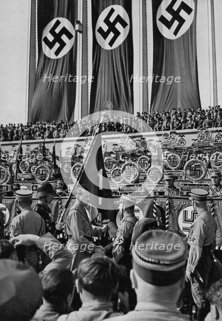 Adolf Hitler dedicates new standards, Nuremberg Rally, Germany, 1934. Artist: Unknown