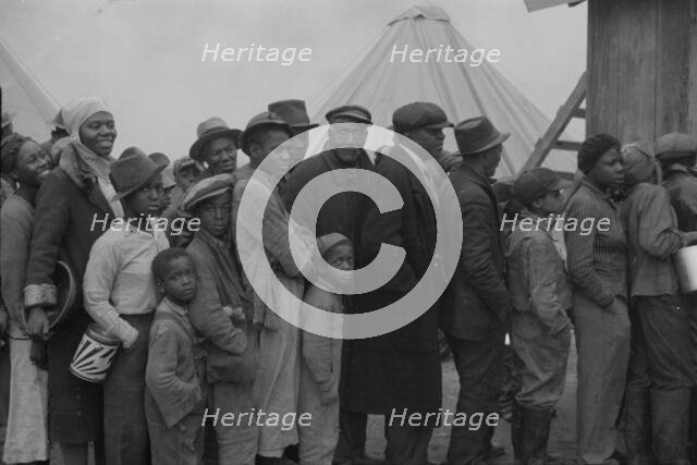 Flood refugees at mealtime, Forrest City, Arkansas, 1937. Creator: Walker Evans.