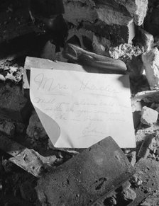A note left in a wrecked house on Independence Avenue, Washington, D.C, 1942. Creator: Gordon Parks.