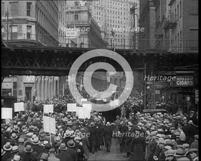 Crowd Walking Parading Down a Road and Holding Signs, 1933. Creator: British Pathe Ltd.