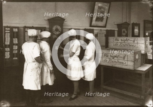 Girls use the clocking in machine, Rowntree factory, York, Yorkshire, 1929. Artist: Unknown