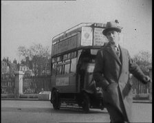 Male Civilian Crossing the Street in Front of Heavy Cars and Buses Traffic, 1920. Creator: British Pathe Ltd.