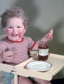 Young child eating P Hartley's Red Plum Jam and bread, c1955.  Creator: Arthur Charles Kirby Ware.