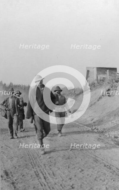 Men walking on dirt road, between c1900 and 1916. Creator: Unknown.