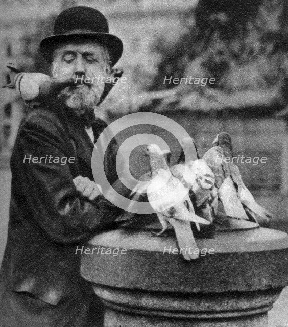 Pigeons of St Paul's with a vagrant, London, 1926-1927.Artist: McLeish