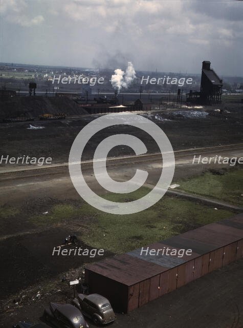 C & NW RR railroad worker cultivating the small Victory garden, Proviso yard, Chicago, Ill., 1943. Creator: Jack Delano.
