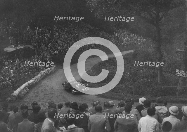 Unidentified open 4-seater car competing in the Shelsley Walsh Hillclimb, Worcestershire, 1935. Artist: Bill Brunell.