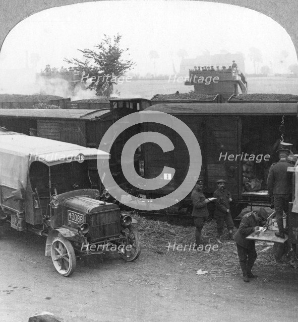 Troops and supplies are rushed from a railhead to the firing line, World War I, c1914-c1918. Artist: Realistic Travels Publishers
