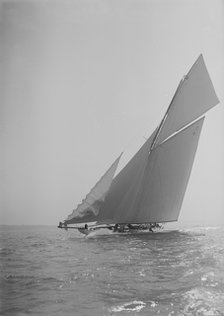 The 19-metre cutter 'Norada' sailing close-hauled, jib flapping, 1911. Creator: Kirk & Sons of Cowes.
