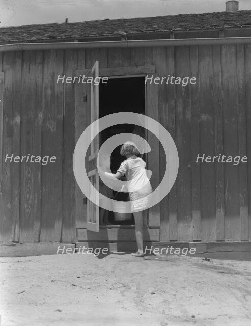 Child of Texas sharecropper carrying water, 1937. Creator: Dorothea Lange.