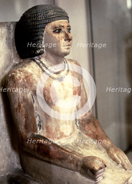 Statue of a seated man, in polychromed limestone.