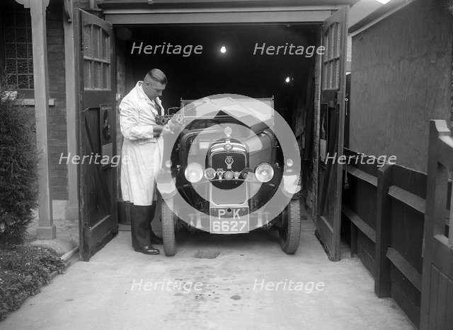 FA Thatcher working on his 1929 Triumph Super Seven. Artist: Bill Brunell.