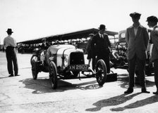 Malcolm Campbell and a Talbot car in the Paddock at Brooklands, Surrey, June 1923. Artist: Unknown