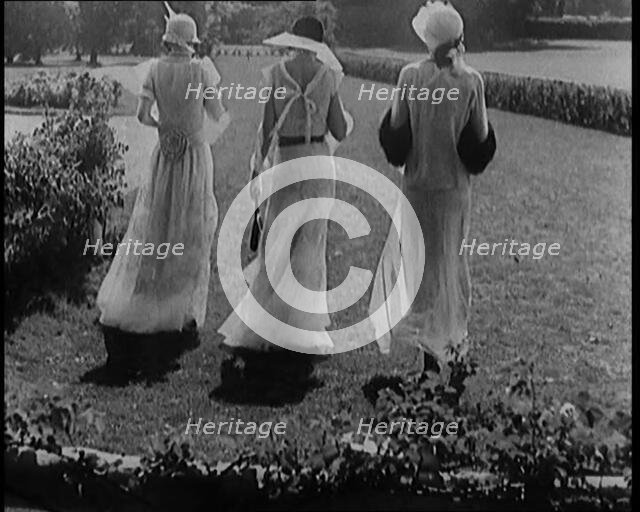 A Group of Three Female Civilians Wearing Fashionable Clothes Standing in a Garden, 1929. Creator: British Pathe Ltd.