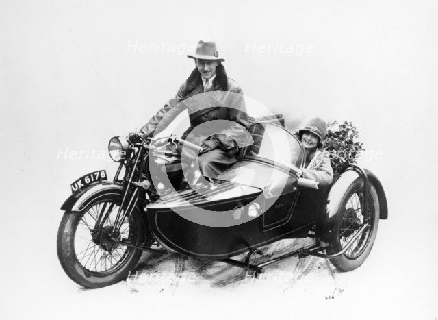 Man riding an AJS motorbike with a woman in the sidecar, 1939. Artist: Unknown