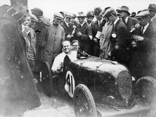 Gordon Taylor in a racing car surrounded by a crowd of men. Artist: Unknown