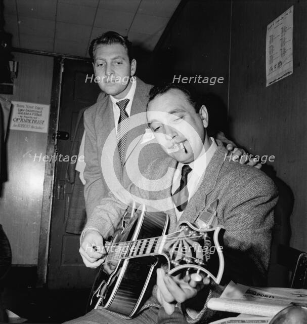 Portrait of Django Reinhardt and David Rose, Aquarium, New York, N.Y., ca. Nov. 1946. Creator: William Paul Gottlieb.