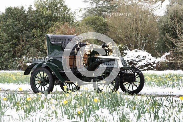 1904 De Dion Bouton model Q in snow with daffodils at Beaulieu. Creator: Unknown.