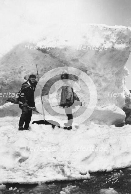 Eskimo with another man in winter scene, between c1900 and 1927. Creator: Lomen Brothers.
