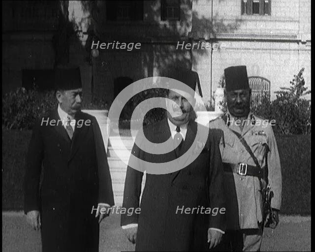 King Faud I Accompanied by One Male Civilian and One Male Soldier Walking Down Steps, 1924. Creator: British Pathe Ltd.