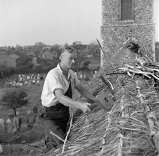 Thatching the roof of St Margaret & All Saints church, Pakefield, Suffolk, 1949. Artist: Hallam Ashley