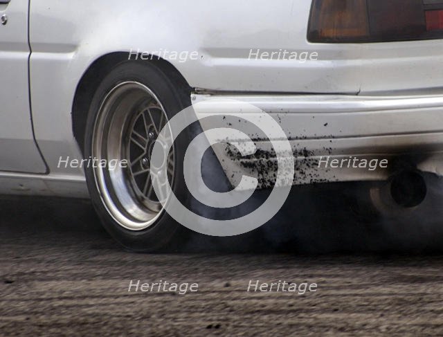 Smoking tyres during tyre burn-out. Creator: Unknown.