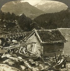 'A log-built mill and a water-wheel grindstone, on Stalheim's river, Naerodal, Norway', c1905. Creator: Unknown.