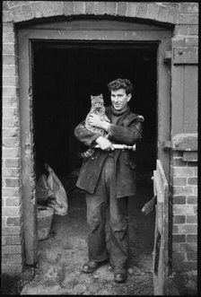 Miller holding a cat, Henley Mill, Henley, Bitterley, Shropshire, 1960-1968. Creator: Rex Wailes.