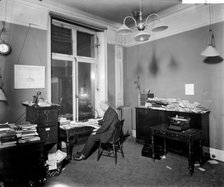 An editor working late in the Morning Post offices at Inveresk House, Westminster, London, 1920. Artist: Bedford Lemere and Company
