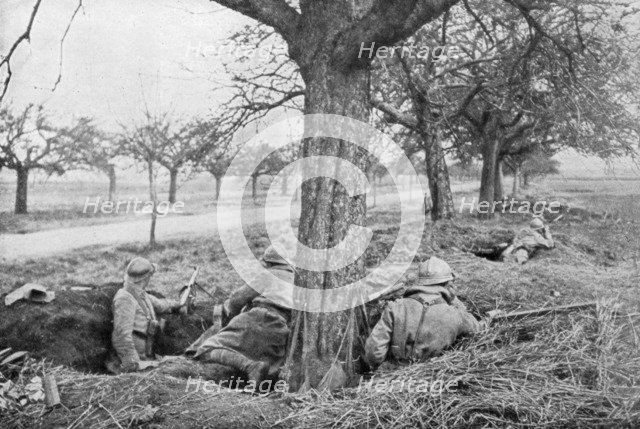 French machine gunners dug in at the edge of a road, under apple trees, 1918. Artist: Unknown