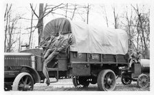 Photo of three soldiers sitting on a truck, Fort Sheridan, Illinois, USA, 1933. Artist: Unknown