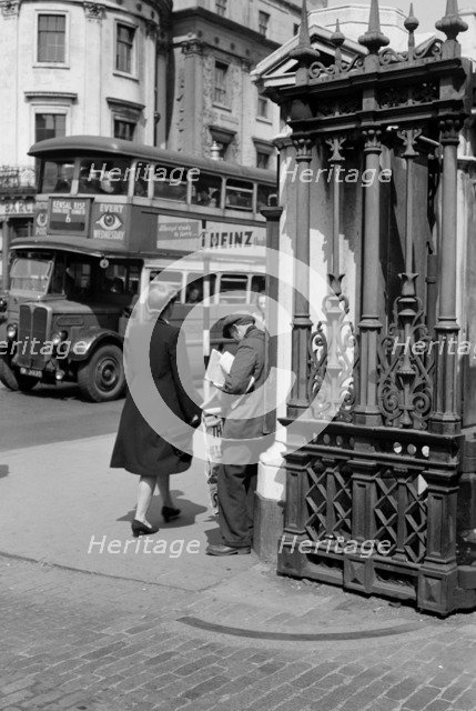 A newspaper seller at Charing Cross Station, London, c1945-c1955. Artist: SW Rawlings