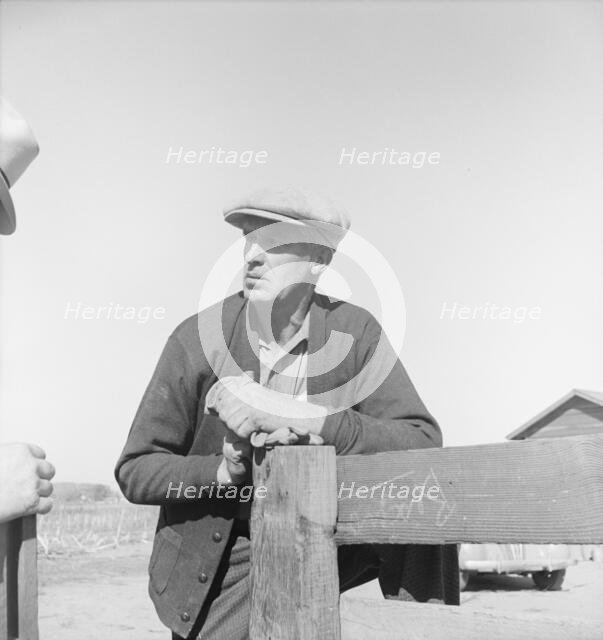 Rehabilitation client talking over fence with county supervisor, near Stockton, CA, 1938. Creator: Dorothea Lange.