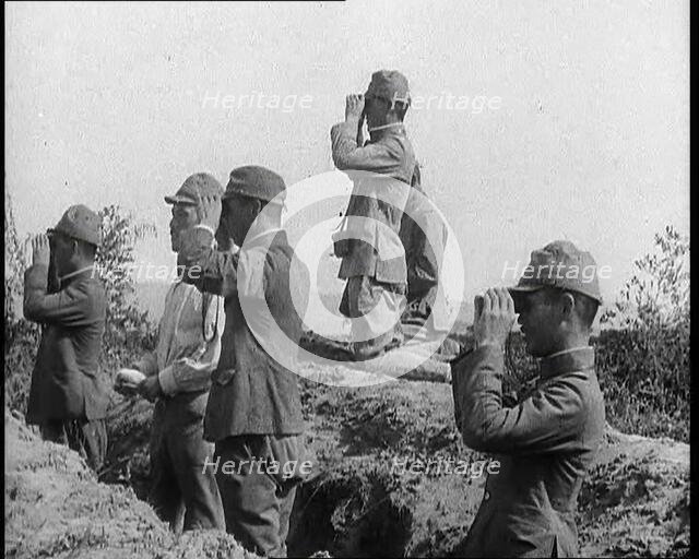 Japanese Soldiers in a Trench Looking Through Binoculars, 1937. Creator: British Pathe Ltd.