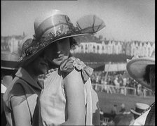 Three Female Civilians Wearing Smart Summer Outfits and Hats Chatting at the Horse Race, 1920. Creator: British Pathe Ltd.
