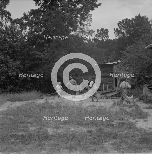 Noontime chores on Negro tenant farm, Granville County, North Carolina, 1939. Creator: Dorothea Lange.