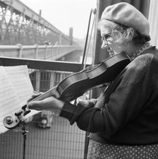 Woman busker playing the violin, Hungerford Bridge, London, 1946-1959. Artist: John Gay
