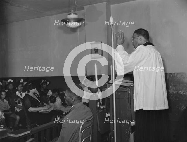Reverend Vondell Gassaway, pastor of the St. Martin's Spiritual Church..., Washington, D.C., 1942. Creator: Gordon Parks.